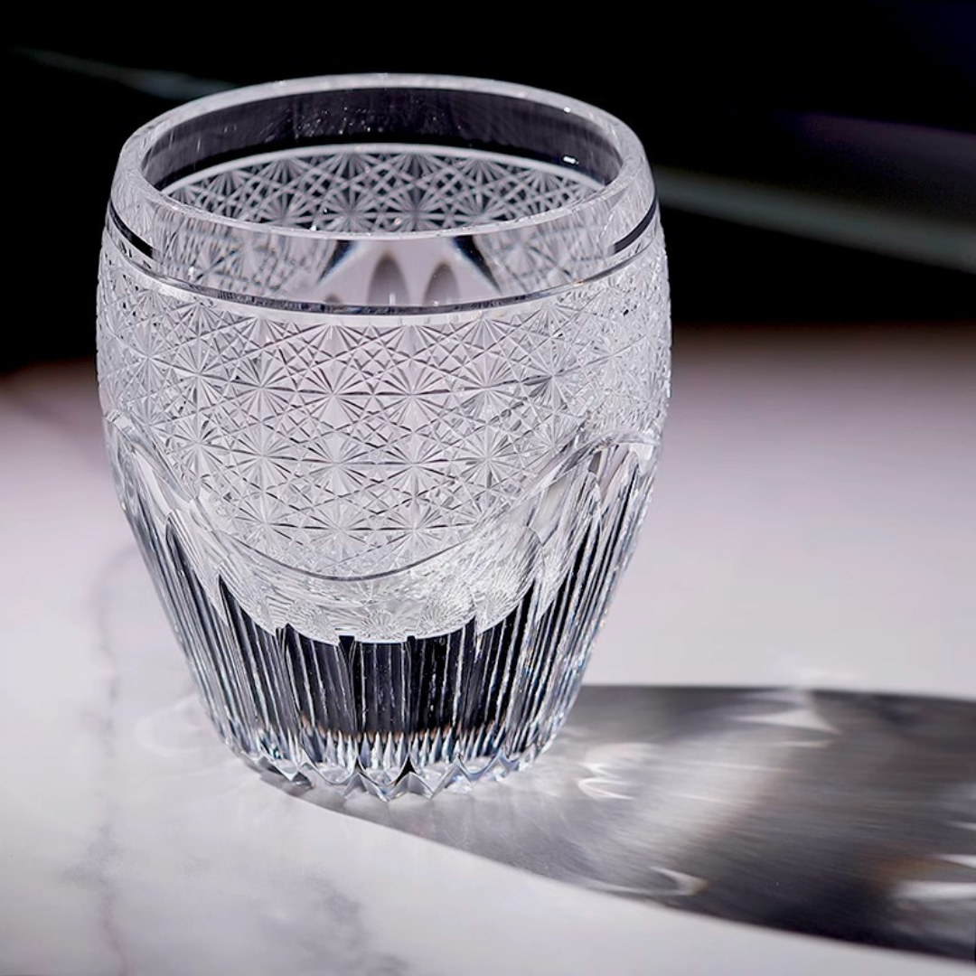 Handcrafted K9 crystal whisky glass with an intricate Edo Kiriko design, reflecting light from its elaborate details.