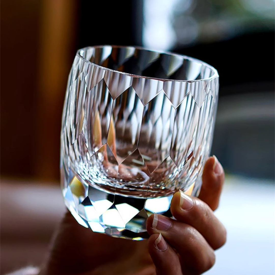 Hand holding our Starlight Kiriko Diamond Whisky Glass - handcrafted crystal whisky glass featuring a stunning starlight-inspired design with intricate diamond-cut detailing.