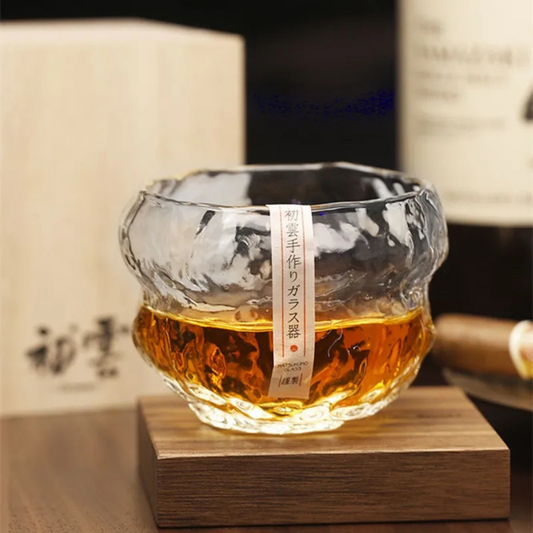 Handcrafted whisky glass with an organic, wavy texture, filled with whisky. Made from premium crystal for a unique and luxurious drinking experience.