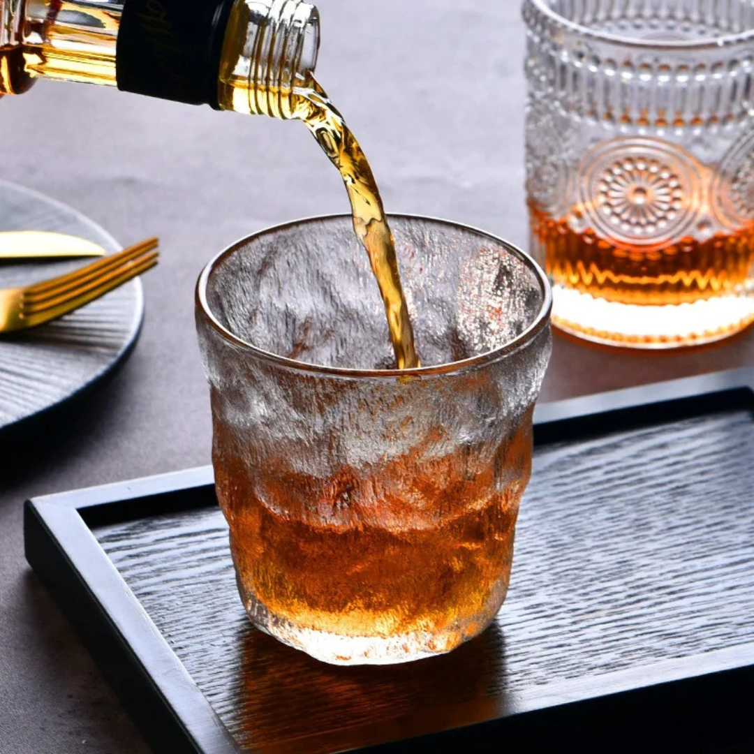 Pouring whisky in our handcrafted retro-inspired whisky glass with a unique textured surface.