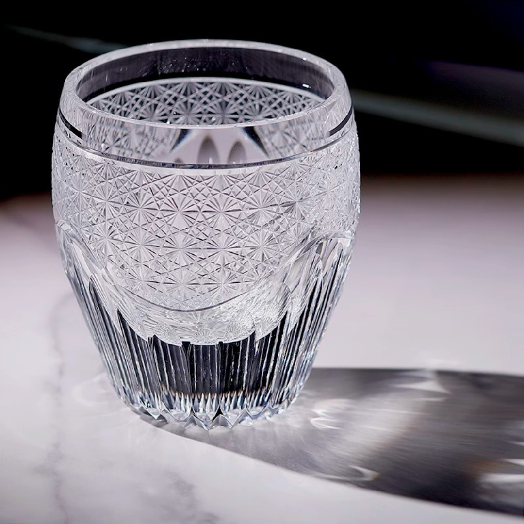 Handcrafted K9 crystal whisky glass with an intricate Edo Kiriko design, reflecting light from its elaborate details. 