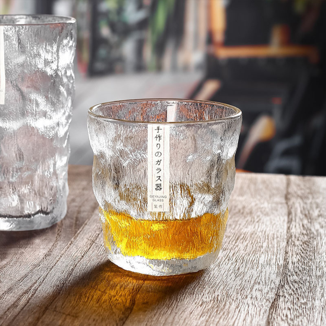 Handcrafted retro-inspired whisky glass with a unique textured surface, filled with whisky, placed on a wooden table.