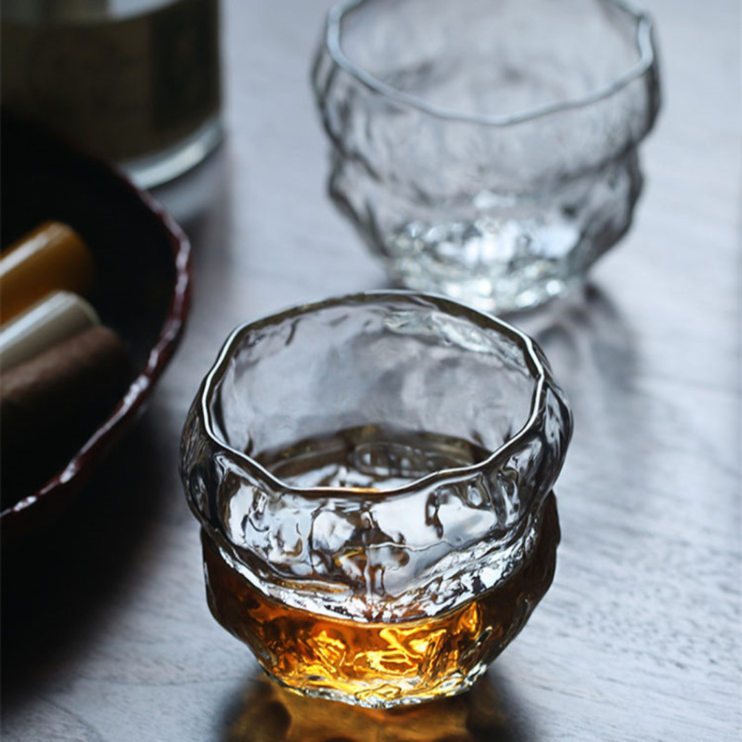 Two handcrafted whisky glass with an organic, wavy texture, filled with whisky. Made from premium crystal for a unique and luxurious drinking experience.