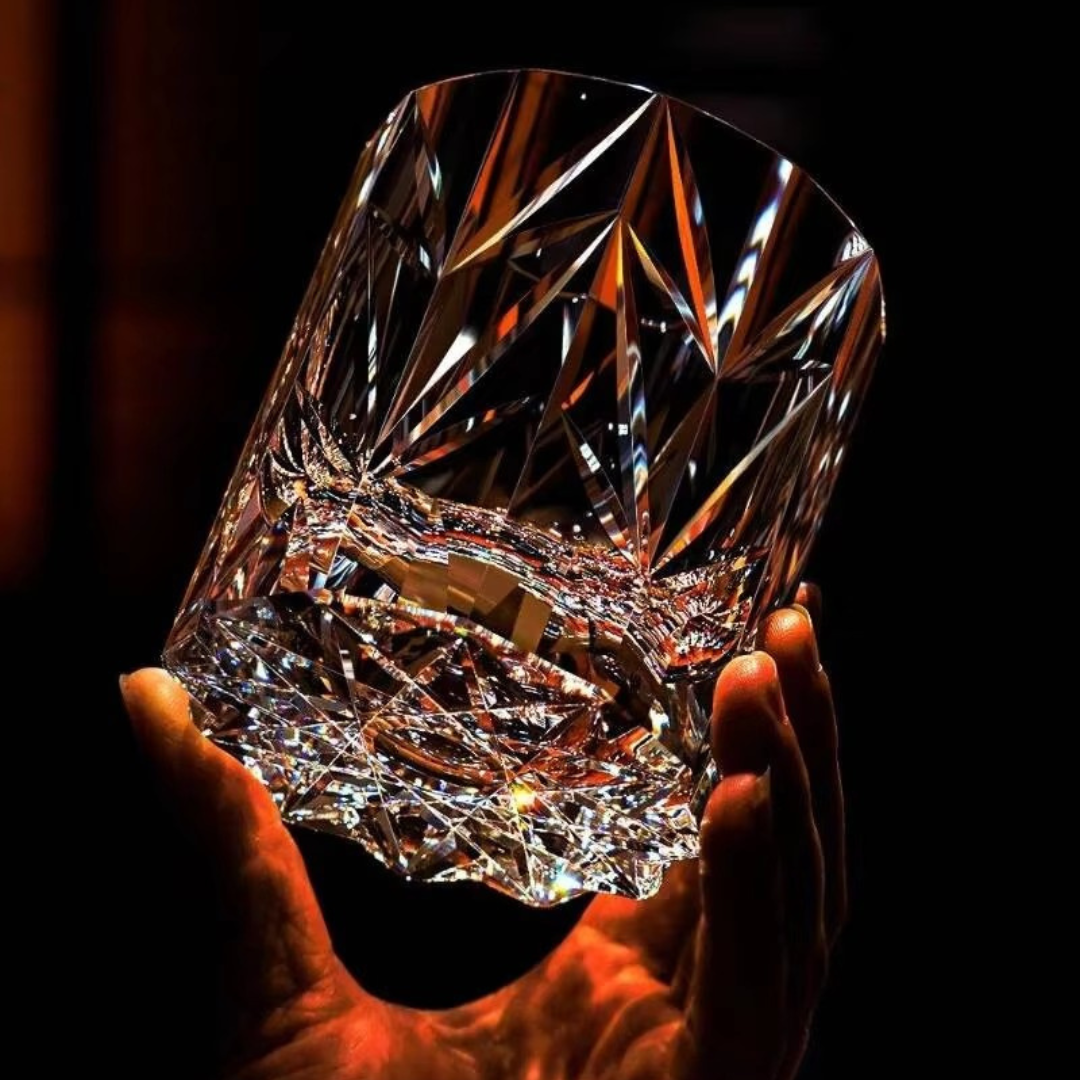 Sparkling Stars Crystal Whisky Glass held in hand showing bold star-cut crystal detailing and sculpted base.