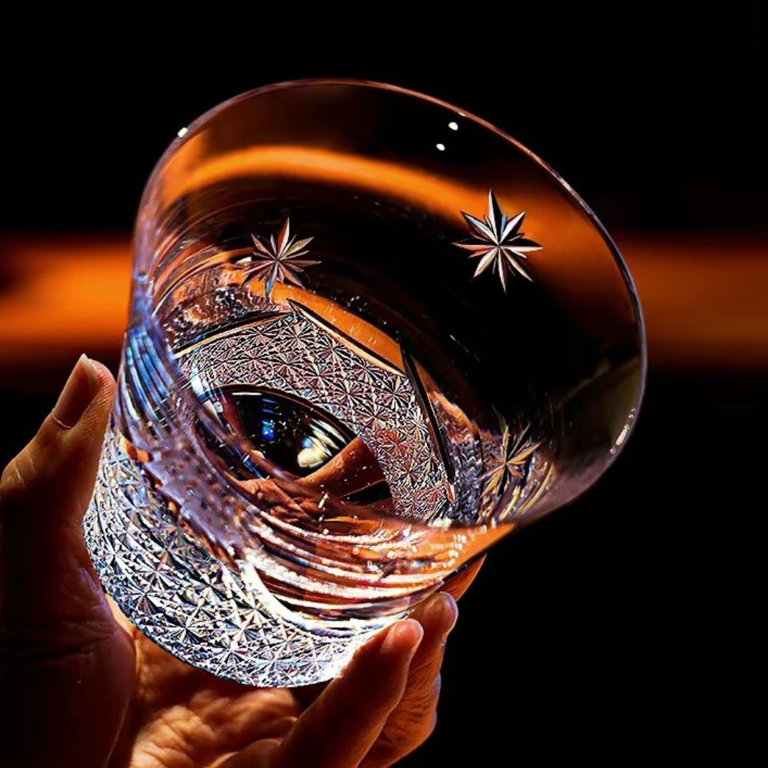 Mount Fuji Flower Crystal Whisky Glass held in hand showing engraved floral and Mount Fuji detailing.