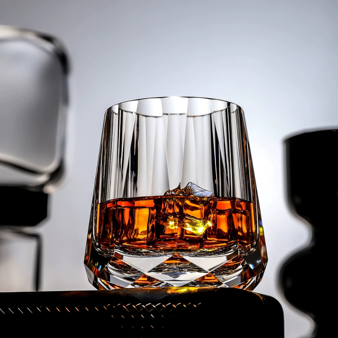 Diamond Cut Crystal Whisky Glass with whisky and ice, showing vertical cuts and sculpted crystal base.