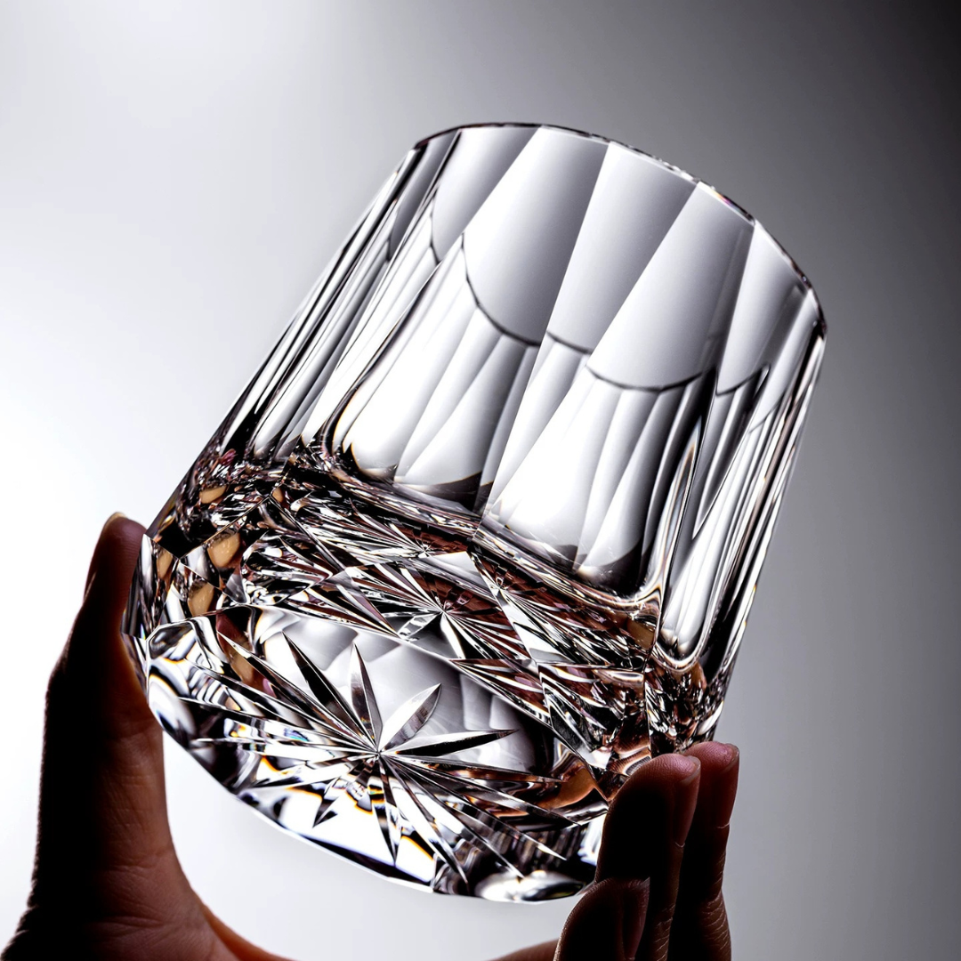 Diamond Cut Crystal Whisky Glass held in hand showing hand-engraved detailing and reflective base.