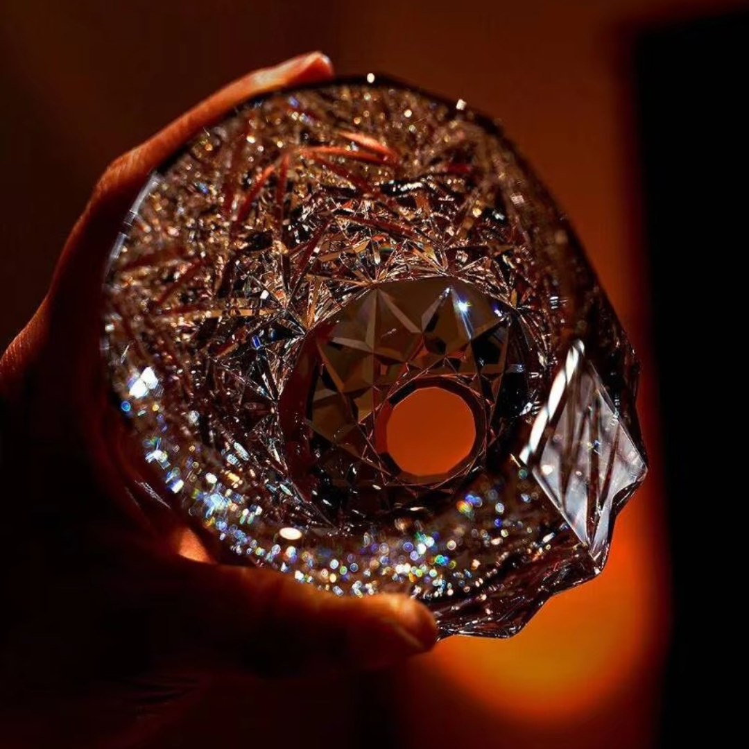 Sparkling Stars Crystal Whisky Glass held in hand showing bold star-cut crystal detailing and sculpted base.