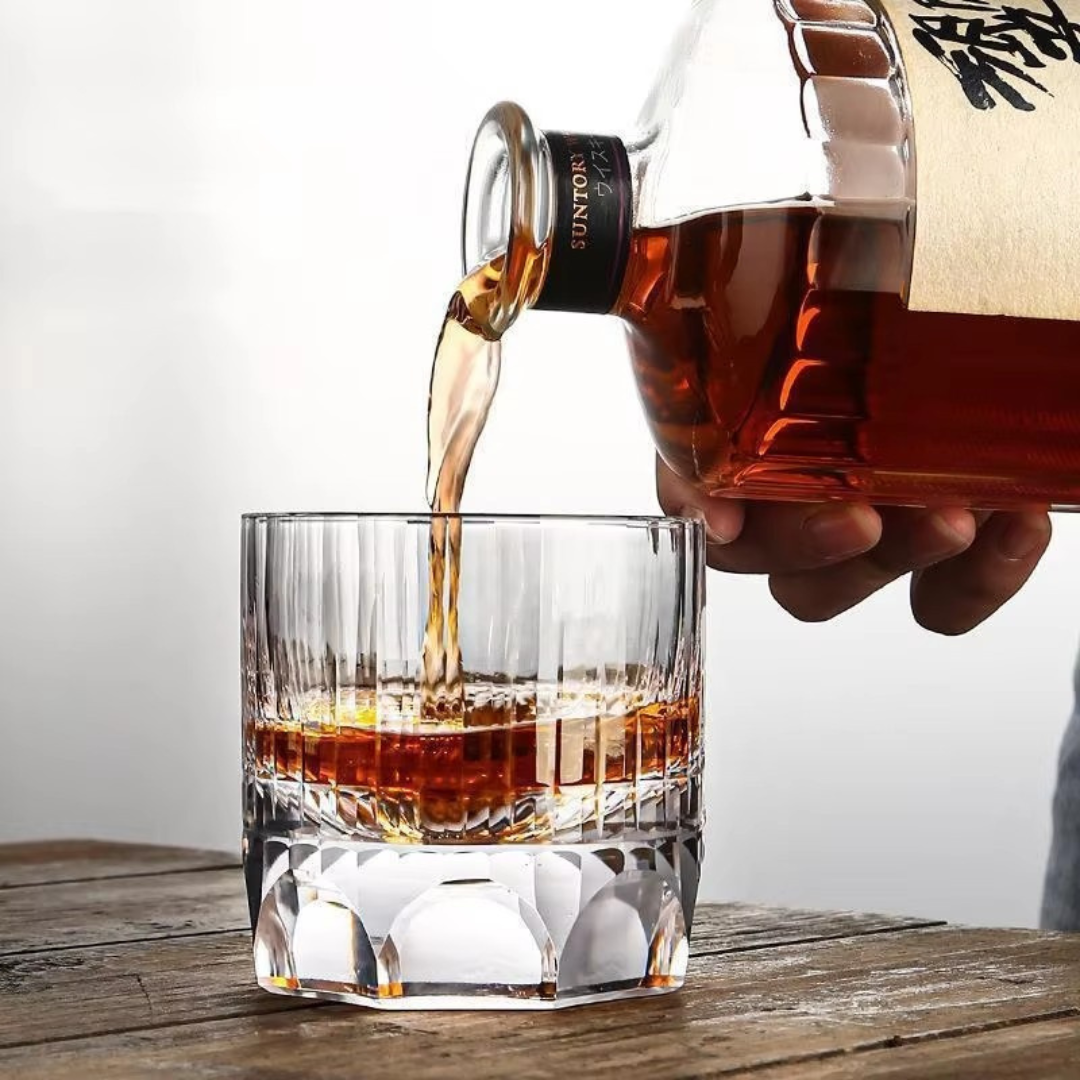 Pouring whisky in our handcrafted K9 crystal whisky glass with a heavy bottom and intricate kiriko cut design, featuring thumbprint-inspired imprints for a comfortable grip.