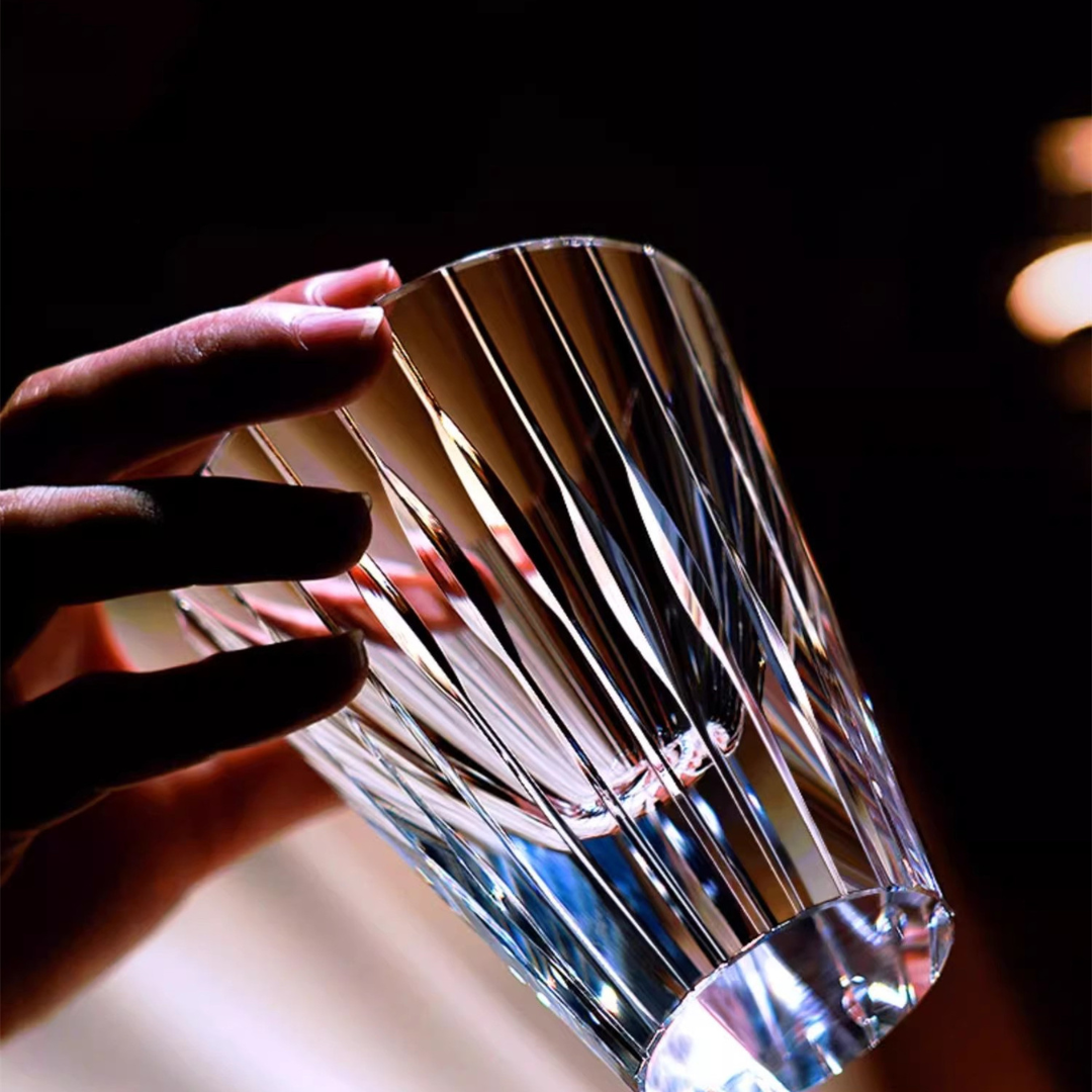 Holding our handcrafted crystal whisky glass inspired by the Japanese Koto instrument