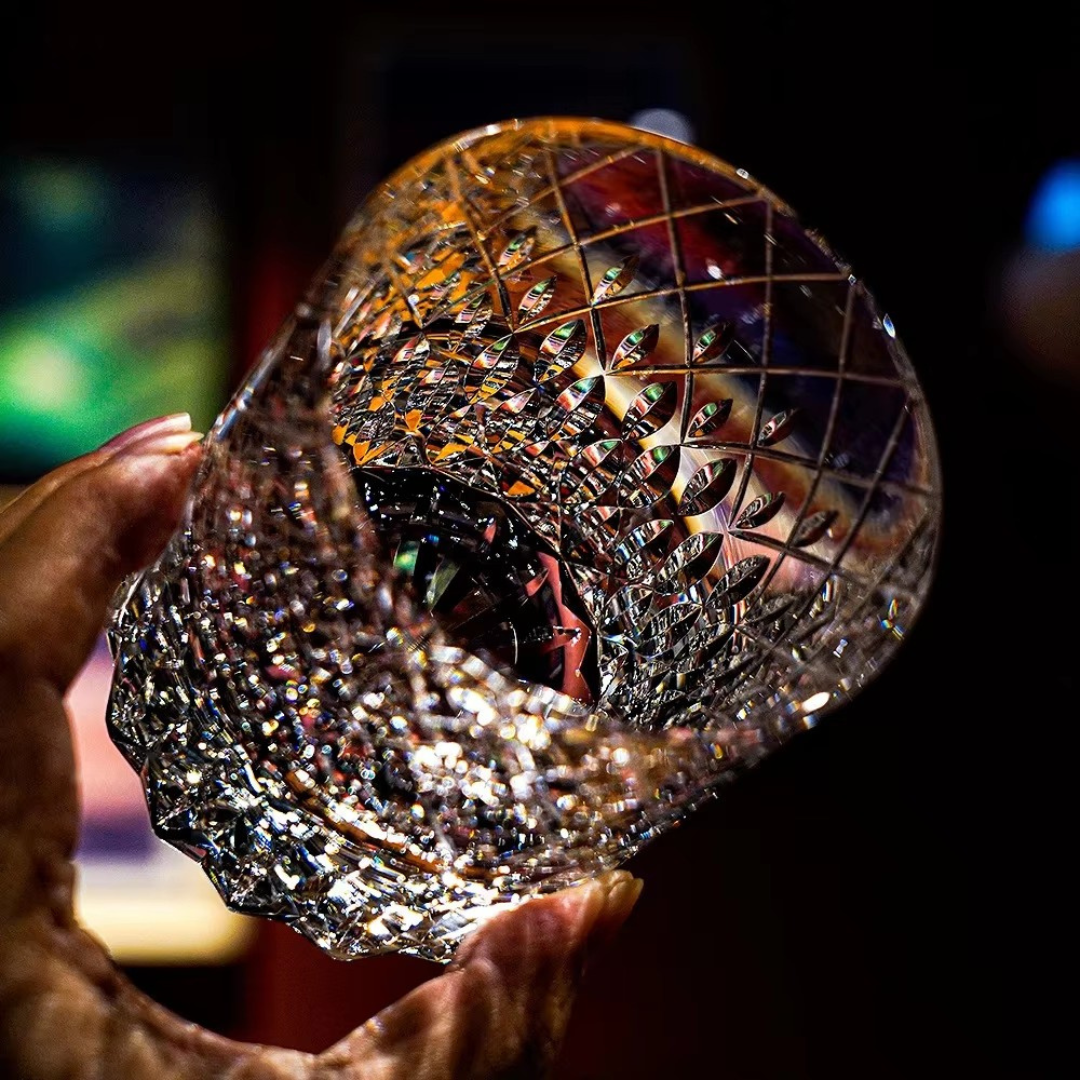 Starry Rain Crystal Whisky Glass held in hand showing intricate starry rain pattern and cut crystal detail.