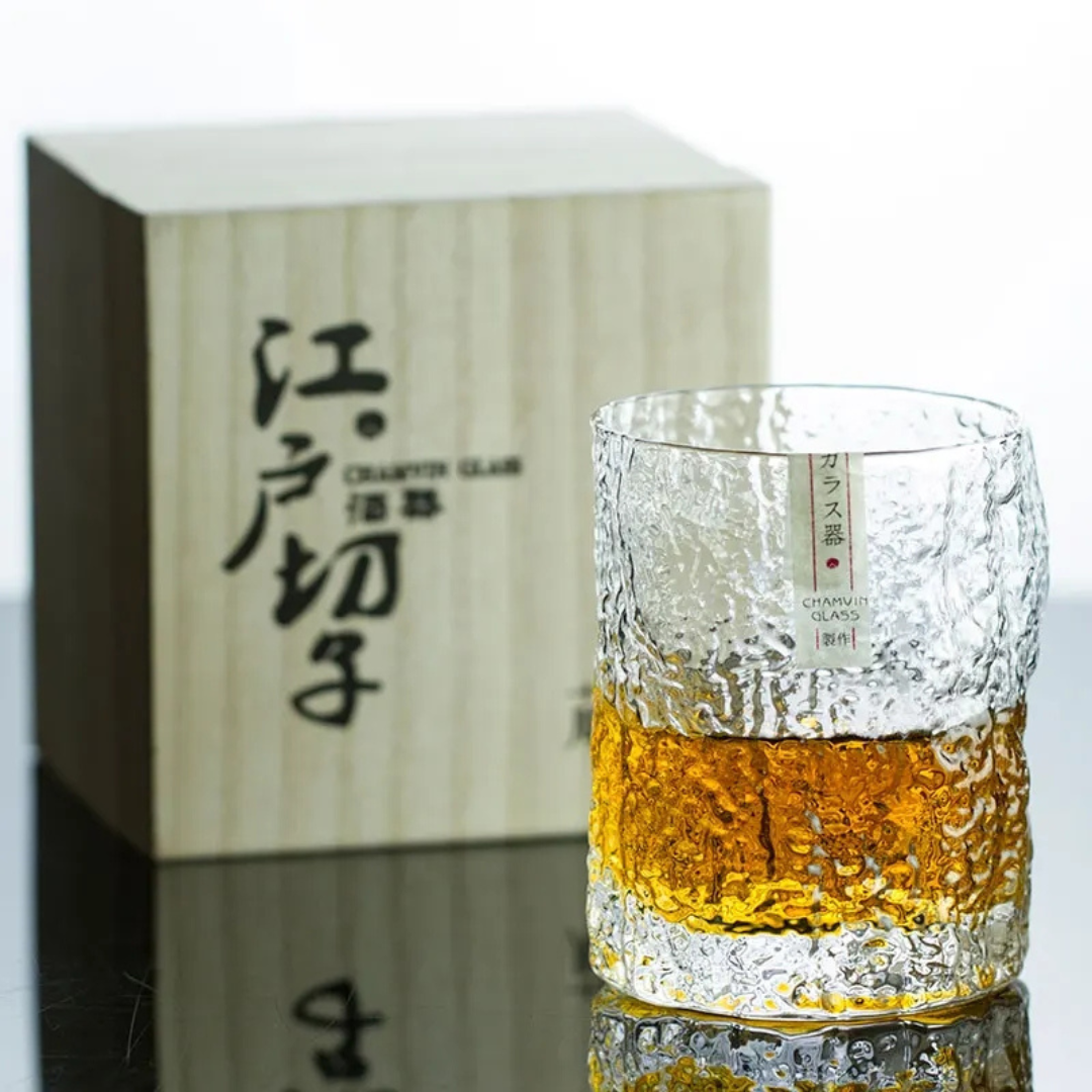 Handcrafted Edo whisky glass with a unique crumple pattern, filled with whisky. The textured crystal surface catches the light, highlighting its artisanal design.