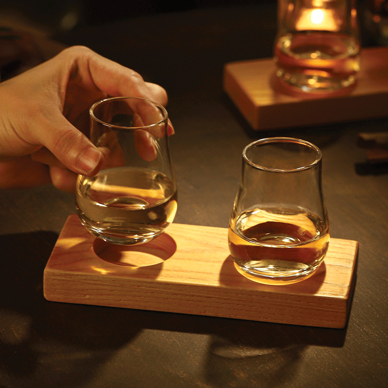 Hand holding the Whisky Glass Set with Natural Wood Tray - Elevate Your Tasting Experience